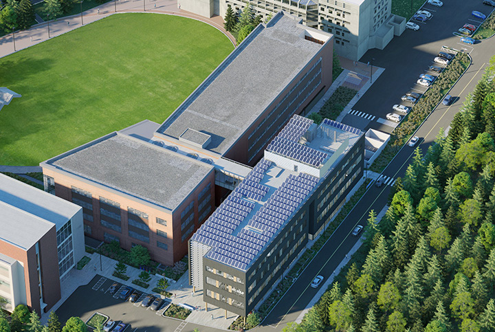 Aerial view of Kaiser Borsari Hall showing solar panels on roof and sky bridge connection to Communications