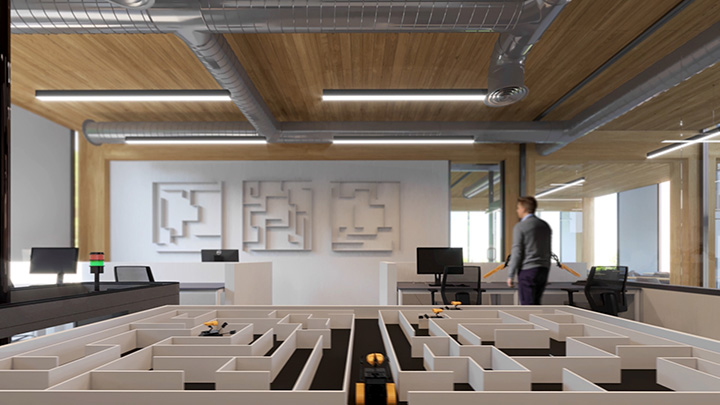lab space with autonomous vehicles navigating a maze and a person in the background