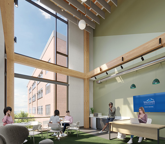 Students in groups talking in a lounge with large windows and high ceilings