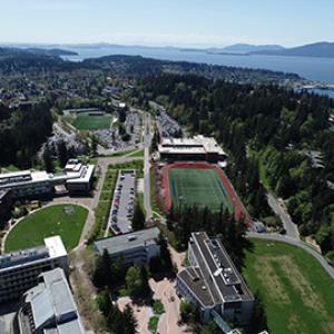 Campus aerial with bay in the background on a sunny day